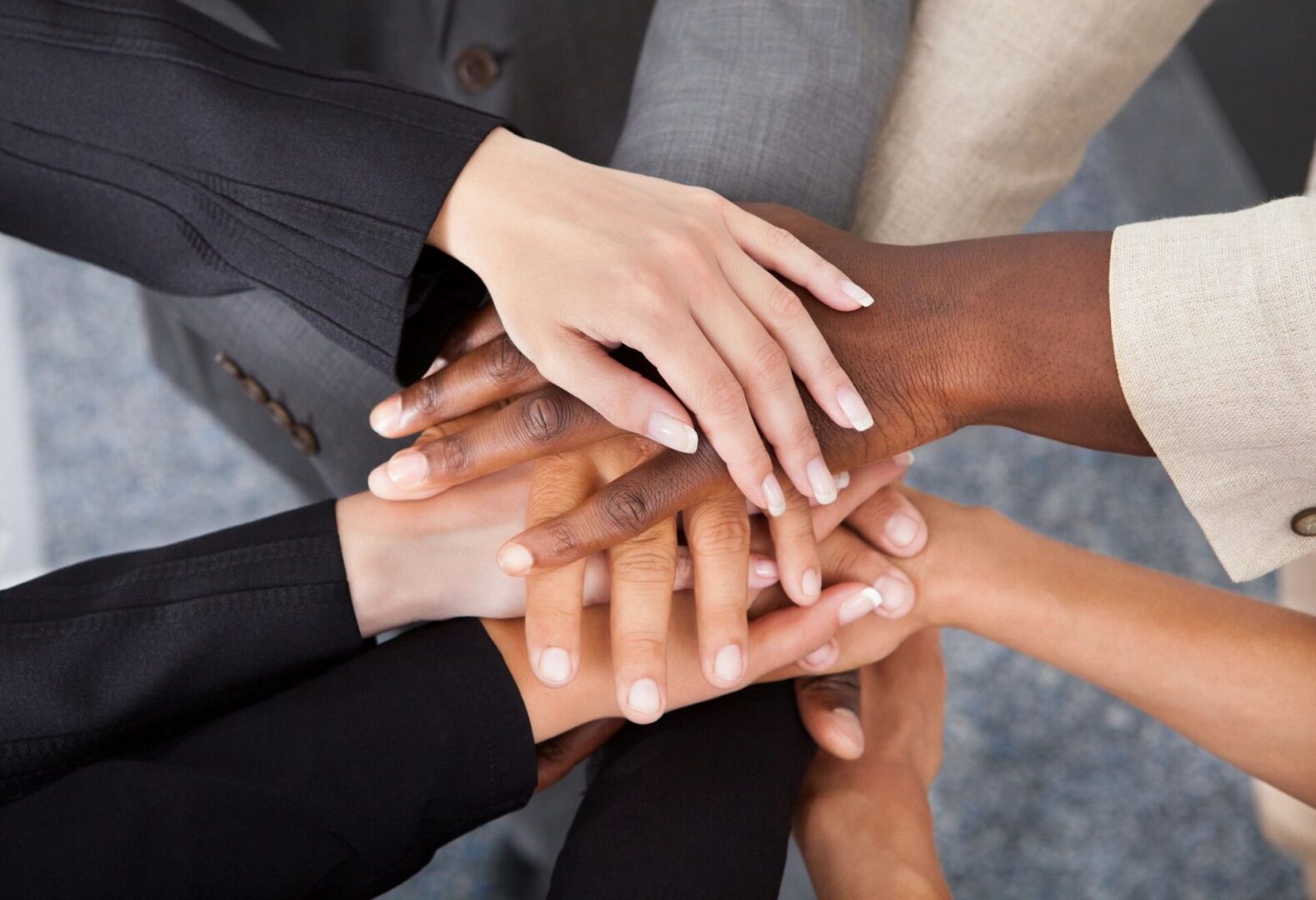 A group of people with their hands together.