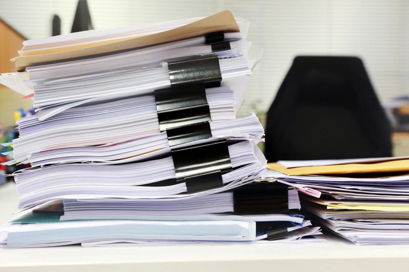 A pile of papers sitting on top of a desk.